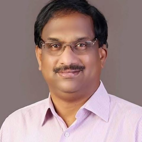 Prof. K. Nageshwar, a head-and-shoulders portrait in a striped shirt